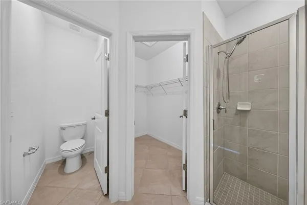 a bathroom with a toilet and a shower