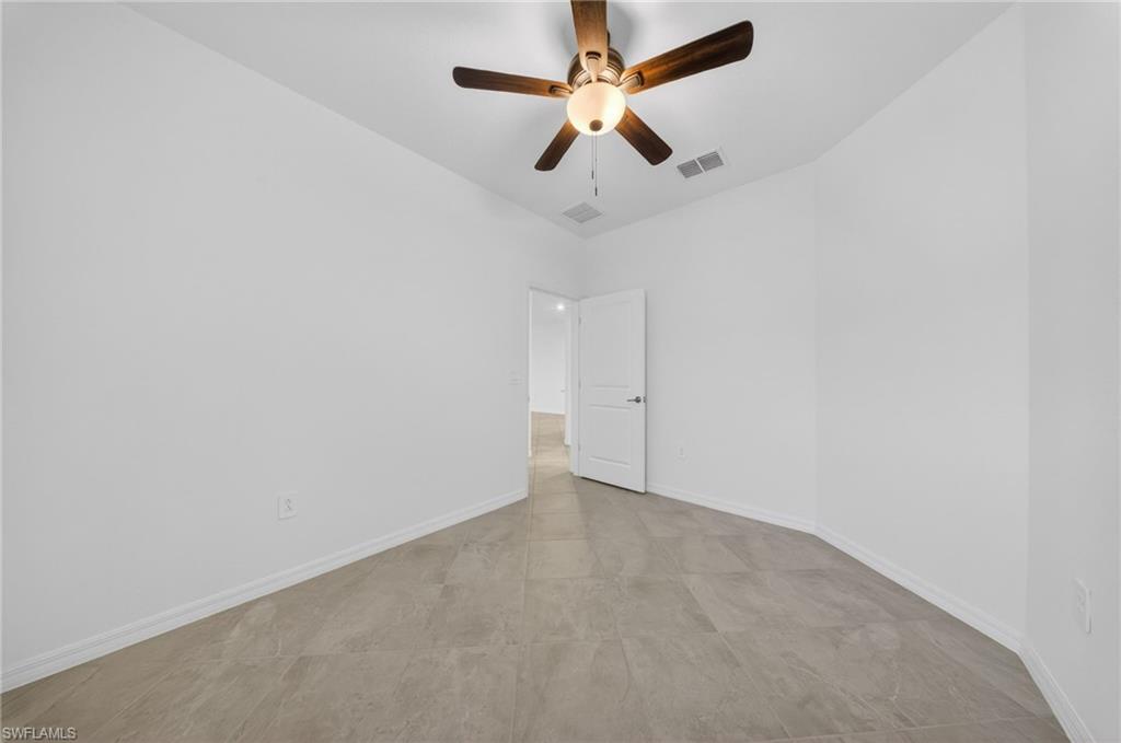 2224 Dragonfruit Way Naples, FL 34120 - Photo 16 of 33 Spare room featuring baseboards and ceiling fan