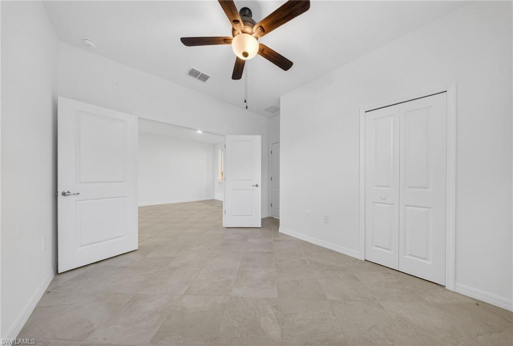 2224 Dragonfruit Way Naples, FL 34120 - Photo 18 of 33 Unfurnished bedroom with ceiling fan and a closet