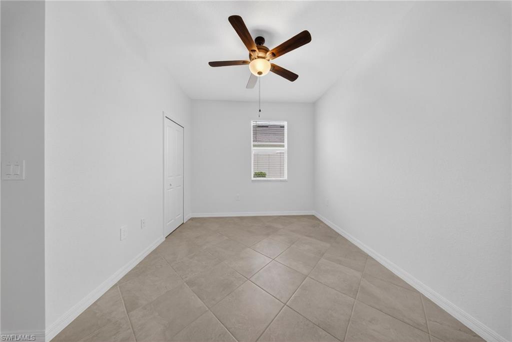 2224 Dragonfruit Way Naples, FL 34120 - Photo 19 of 33 Spare room featuring a ceiling fan and light tile patterned floors