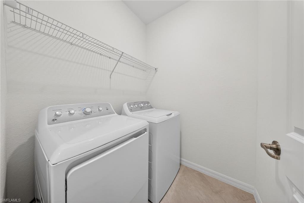 2224 Dragonfruit Way Naples, FL 34120 - Photo 20 of 33 Laundry area with baseboards and separate washer and dryer