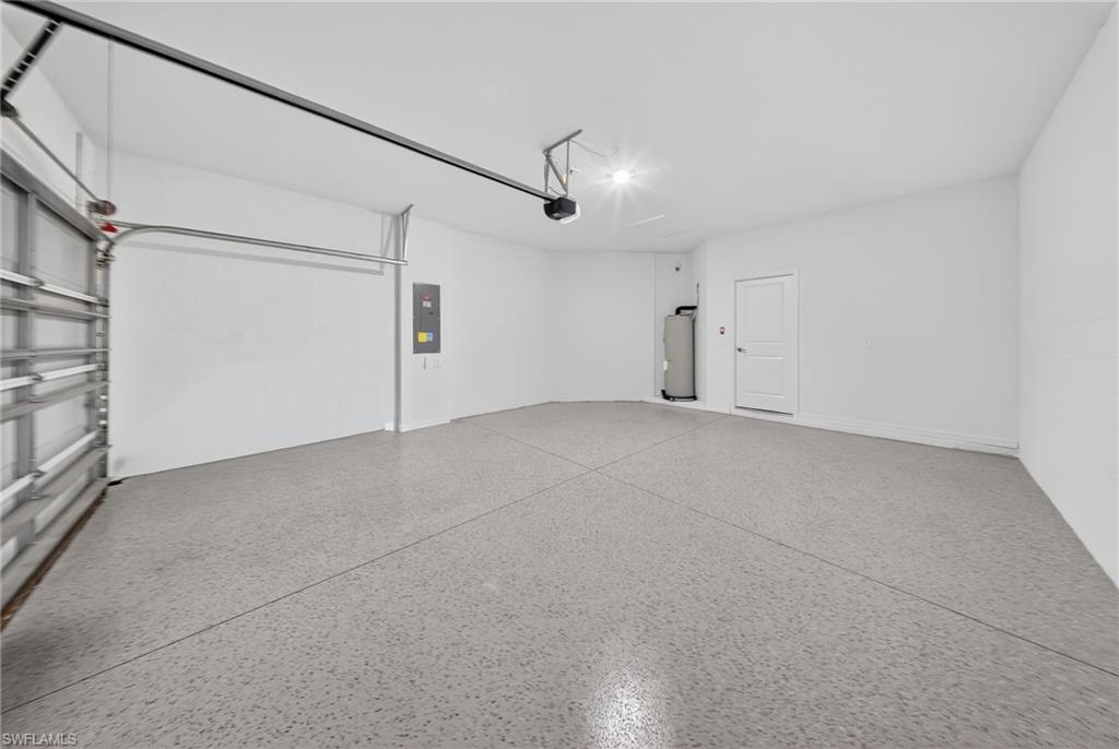 2224 Dragonfruit Way Naples, FL 34120 - Photo 22 of 33 Garage with water heater and electric panel