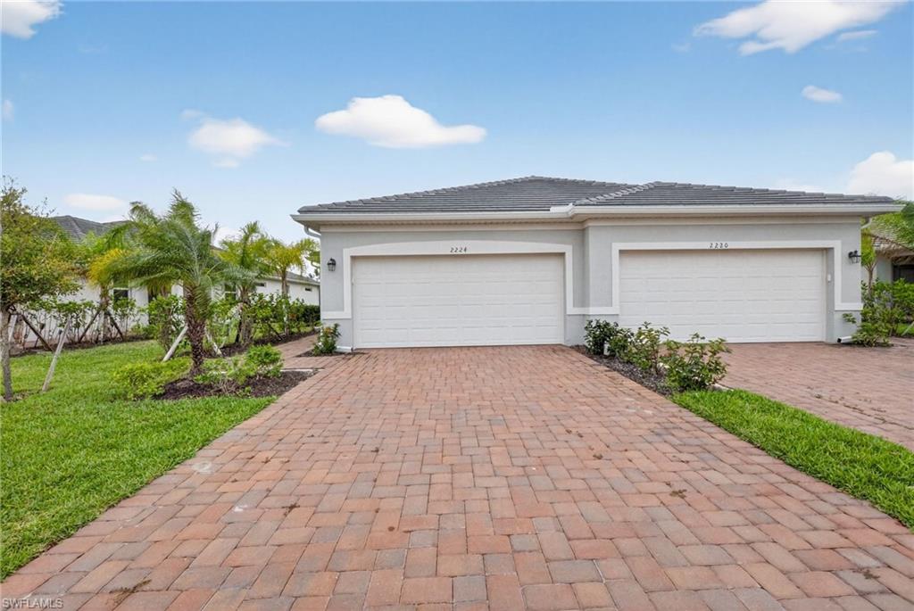 2224 Dragonfruit Way Naples, FL 34120 - Photo 27 of 33 Garage with decorative driveway