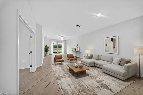 a living room with furniture and a large window