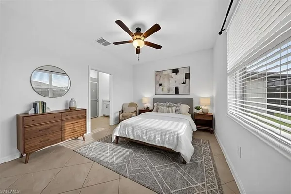 a bedroom with a bed and window