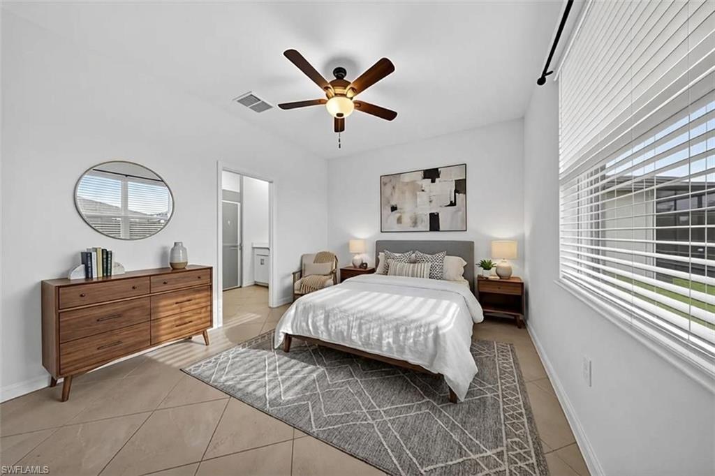 2224 Dragonfruit Way Naples, FL 34120 - Photo 9 of 33 Bedroom featuring a ceiling fan, light tile patterned floors, and multiple windows