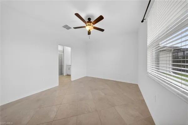 a view of a livingroom with a ceiling fan and window