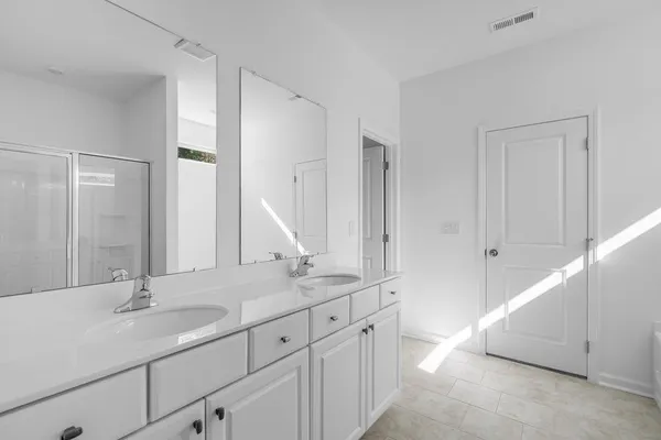 a bathroom with 2 sink tub and a mirror