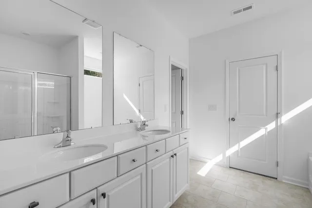 a bathroom with 2 sink tub and a mirror