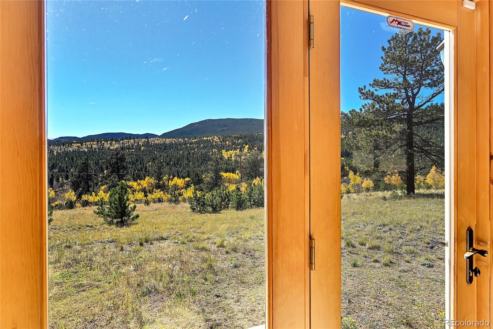278 Clark Road Bailey, CO 80421 - Photo 31 of 44 a view of a glass door with a mountain view