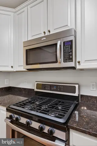 a stove top oven sitting inside of a kitchen