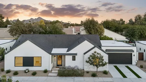a aerial view of a house with a yard and potted plants