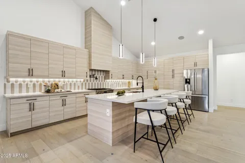 a kitchen with sink and chairs