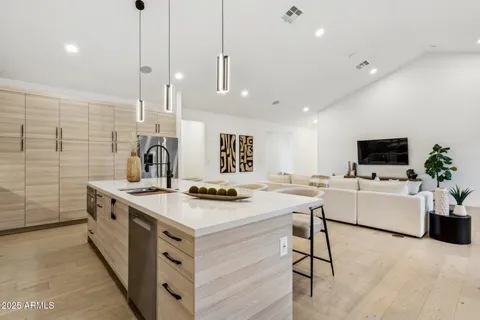 a kitchen with stainless steel appliances kitchen island granite countertop a sink and cabinets