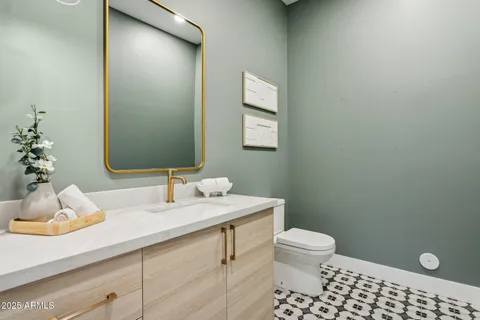 a bathroom with a sink a toilet and a mirror
