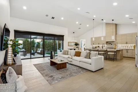 a dining room with furniture and wooden floor