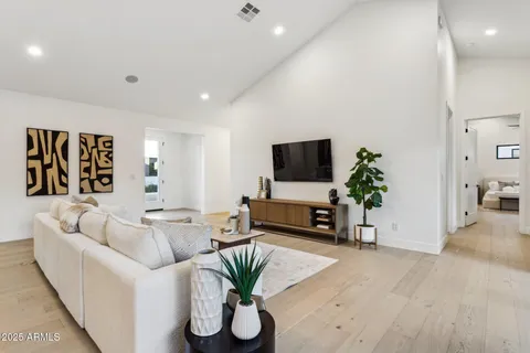 a living room with furniture tv and a large window