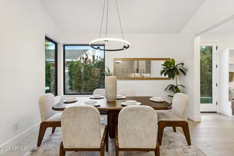 a living room with furniture kitchen view and a potted plant