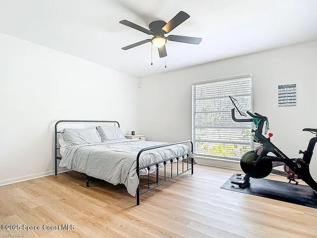 a bedroom with bed and glass door