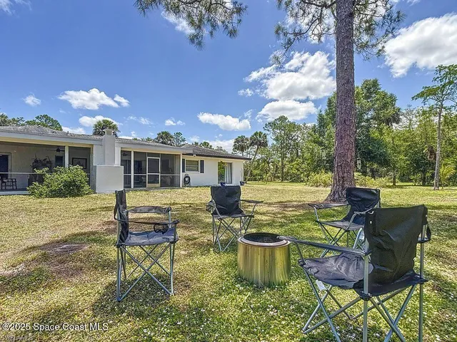 a front view of house with yard seating and outdoor seating
