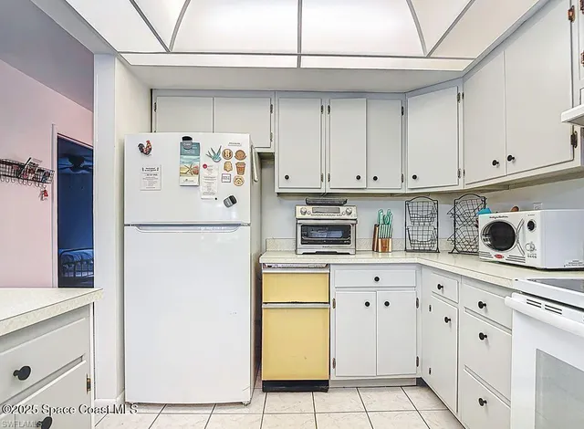 a kitchen with stainless steel appliances a refrigerator sink and cabinets