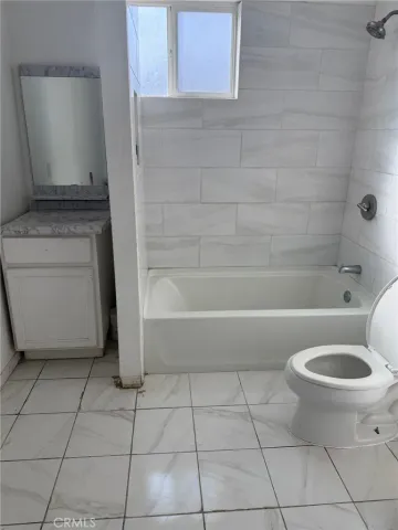 a bathroom with a toilet and a bathtub