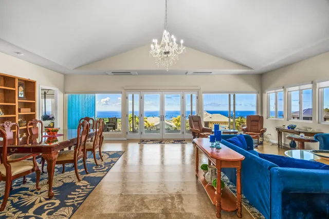 a very nice looking living room with furniture and a chandelier
