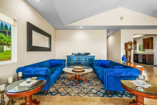 a living room with furniture a table and chair