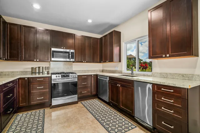 a kitchen with a sink stove and microwave