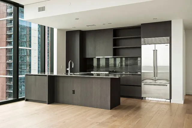 a kitchen with stainless steel appliances granite countertop a refrigerator and a sink