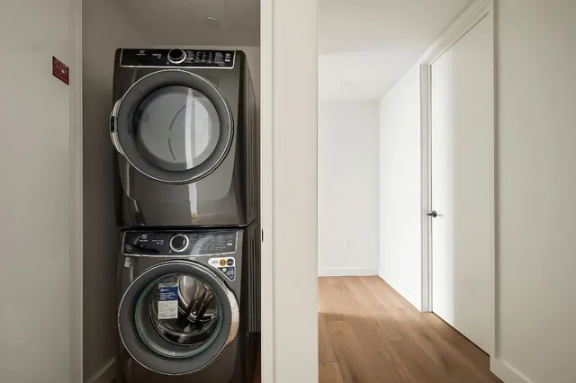 a view of a hallway with washer and dryer