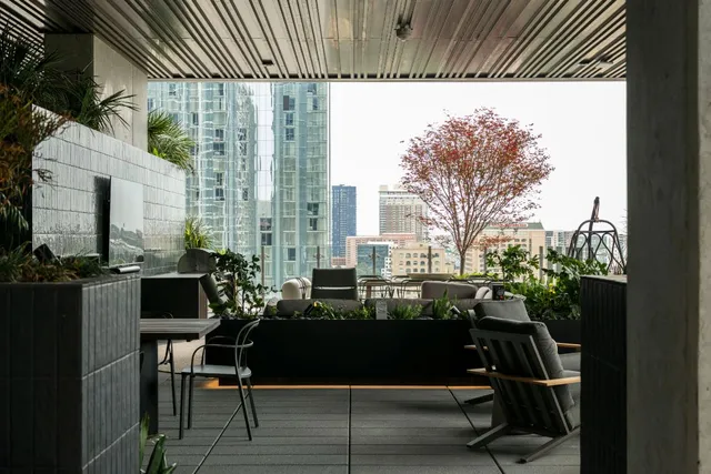 a view of a balcony with chairs and table in a patio