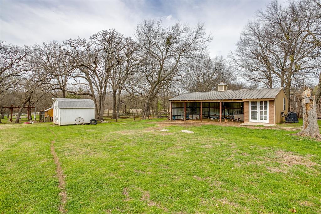 1615 Sanger Drive Springtown, TX 76082 - Photo 34 of 40 a front view of a house with a garden