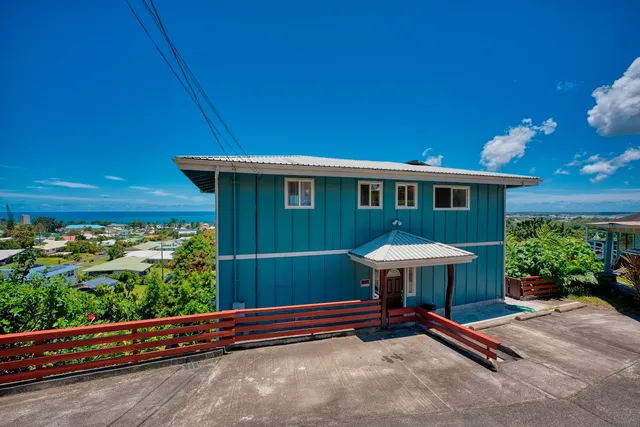 a view of a backyard with table and chairs under an umbrella