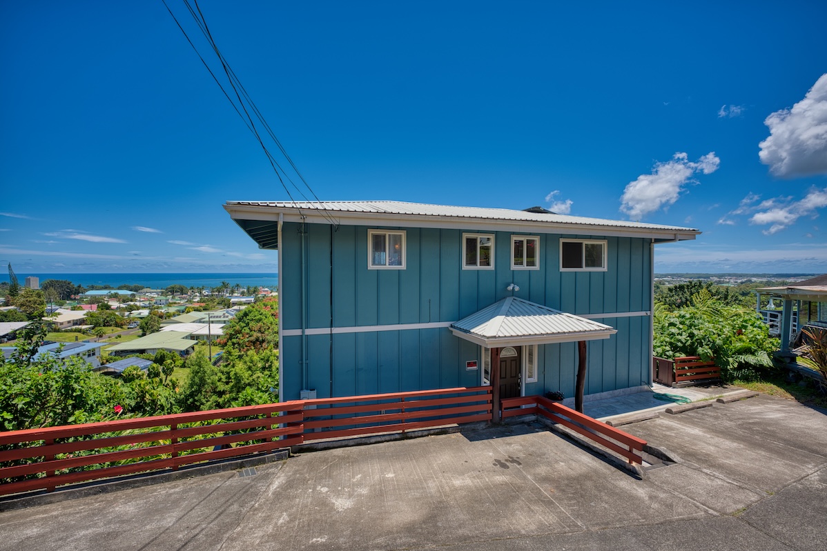 149 Halai Street Hilo, HI 96720 - Photo 1 of 26 a view of a backyard with table and chairs under an umbrella