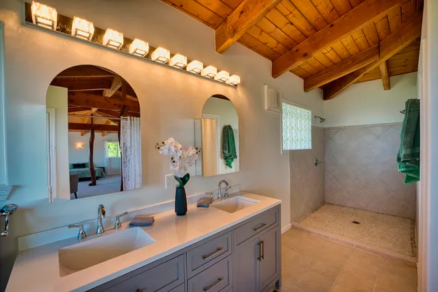 a bathroom with a double vanity sink and a mirror