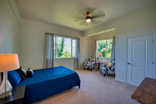 a bed room with a bed and a chair