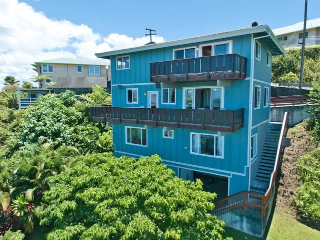 a view of a house with brick walls and plants