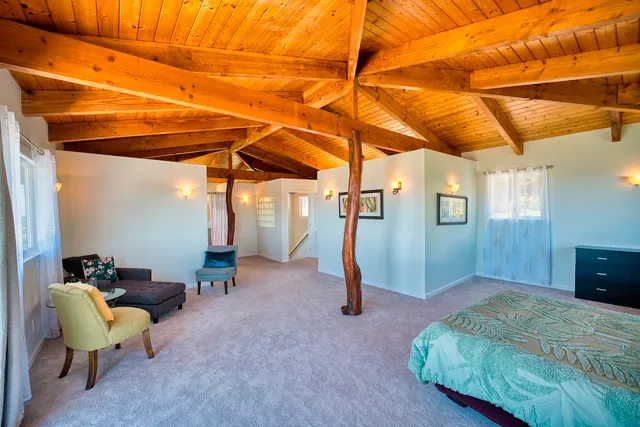 a bed room with a bed and a chair