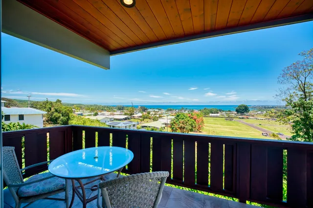 a view of a balcony with a table and chairs