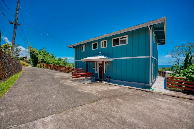 a view of a backyard with potted plants and a table and chairs