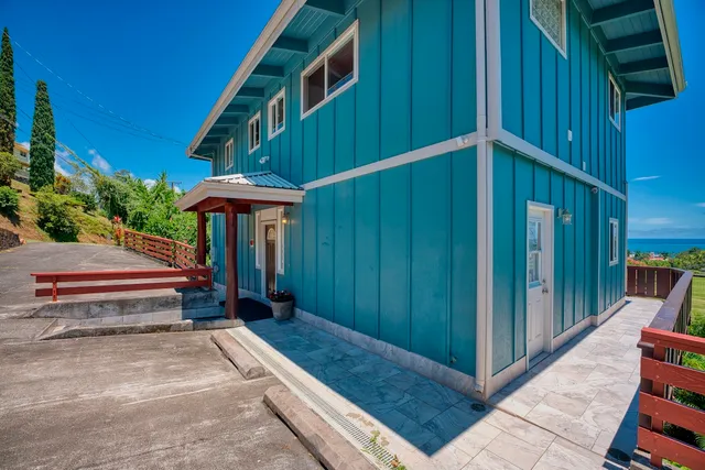 a backyard of a house with barbeque oven table and chairs