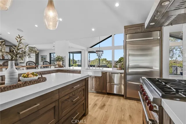 a kitchen with stainless steel appliances granite countertop a sink and a stove