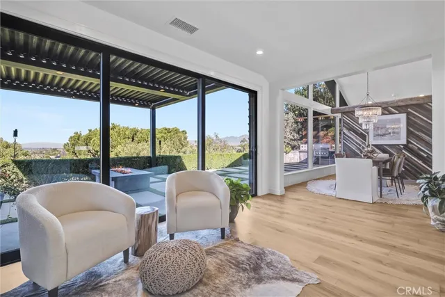 a living room with furniture and a floor to ceiling window