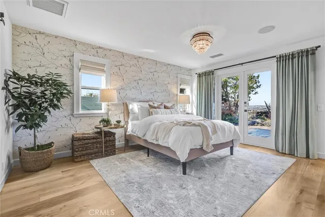 a spacious bedroom with a bed and a potted plant