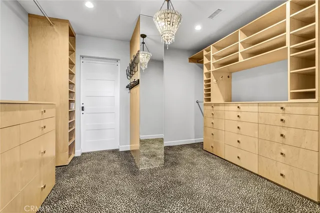 a view of walk in closet and window