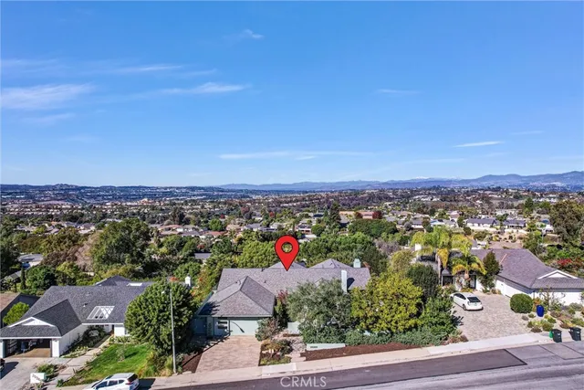 an aerial view of a city and mountain view in back