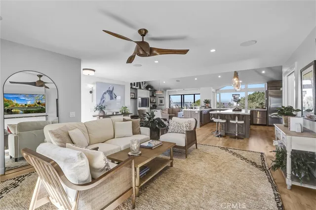 a living room with furniture and a view of kitchen