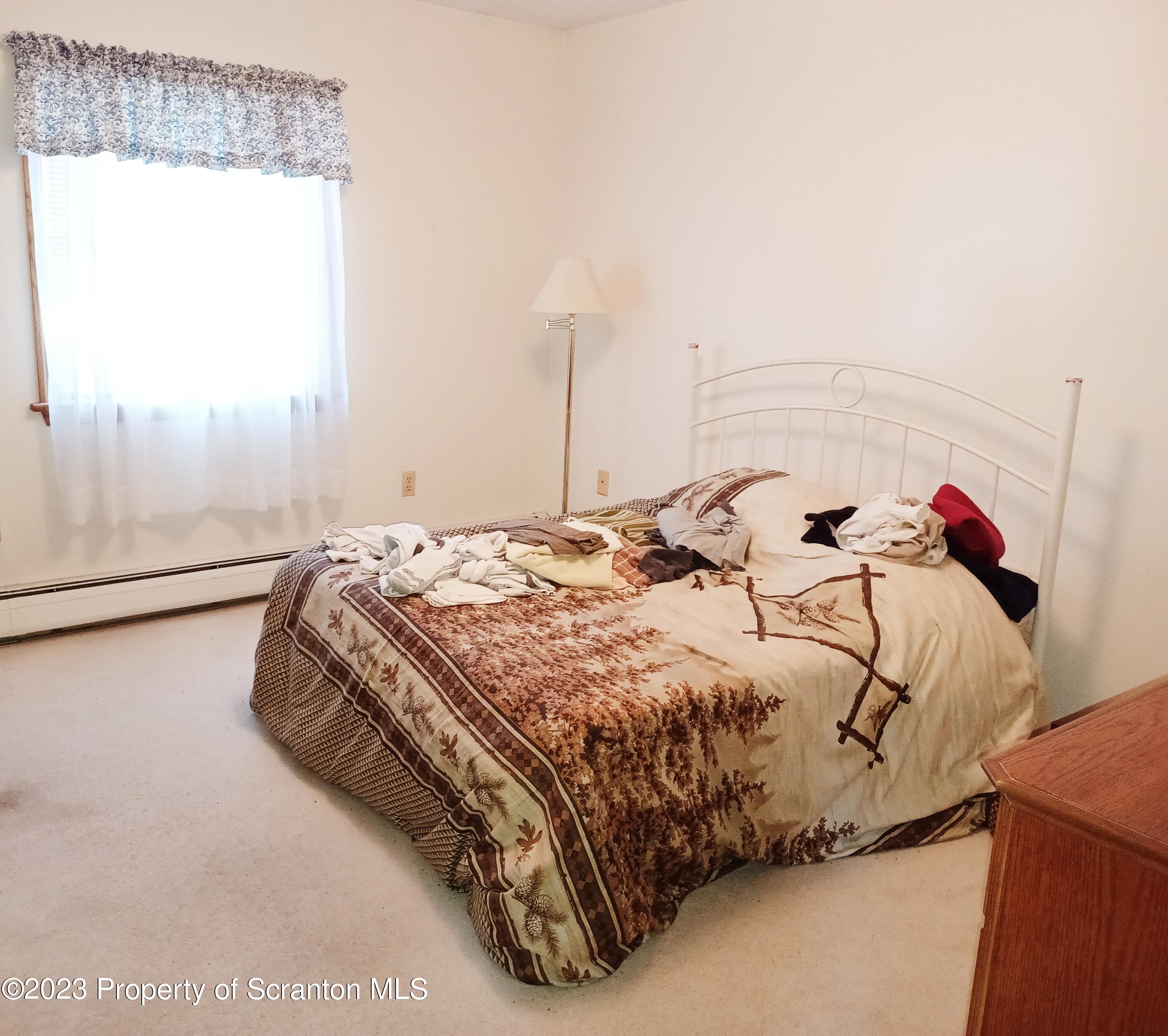 565 Spring Run Lane Moscow, PA 18444 - Photo 8 of 29 a bedroom with a bed and a window