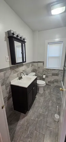 a bathroom with a sink vanity and mirror